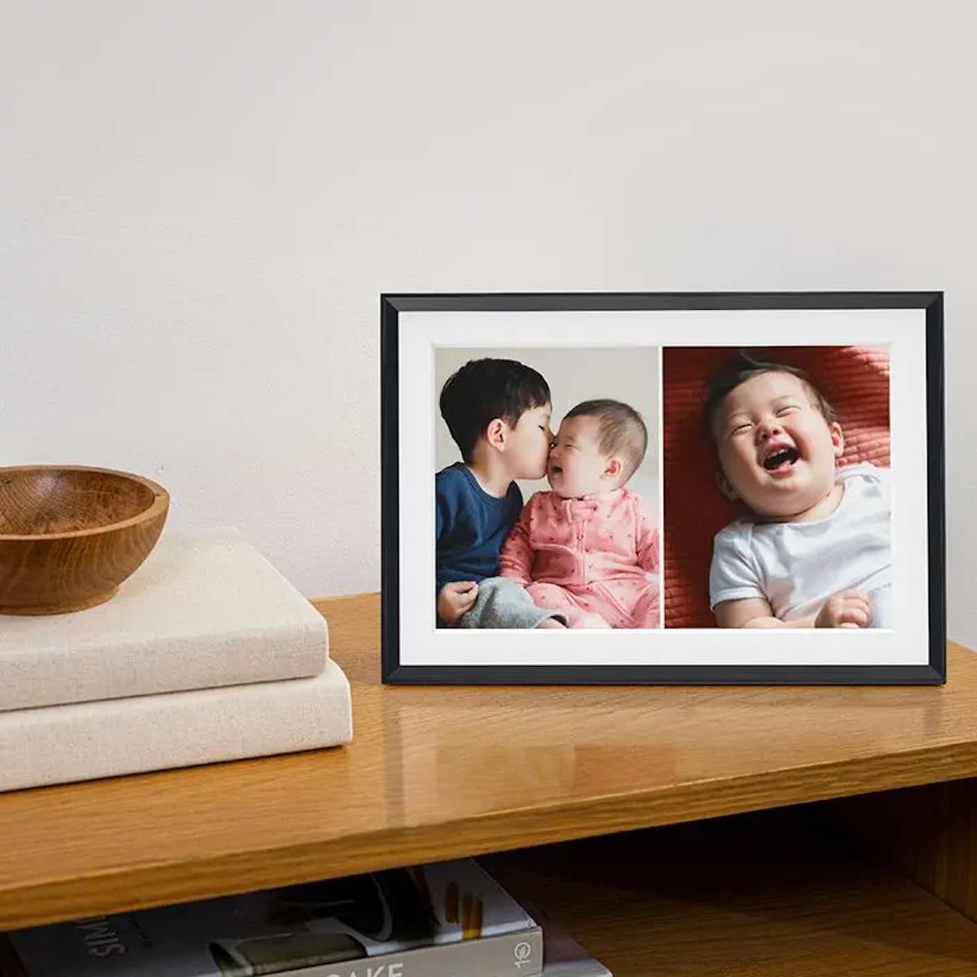 A digital picture frame on a table.