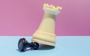chess peg on top of another chess peg