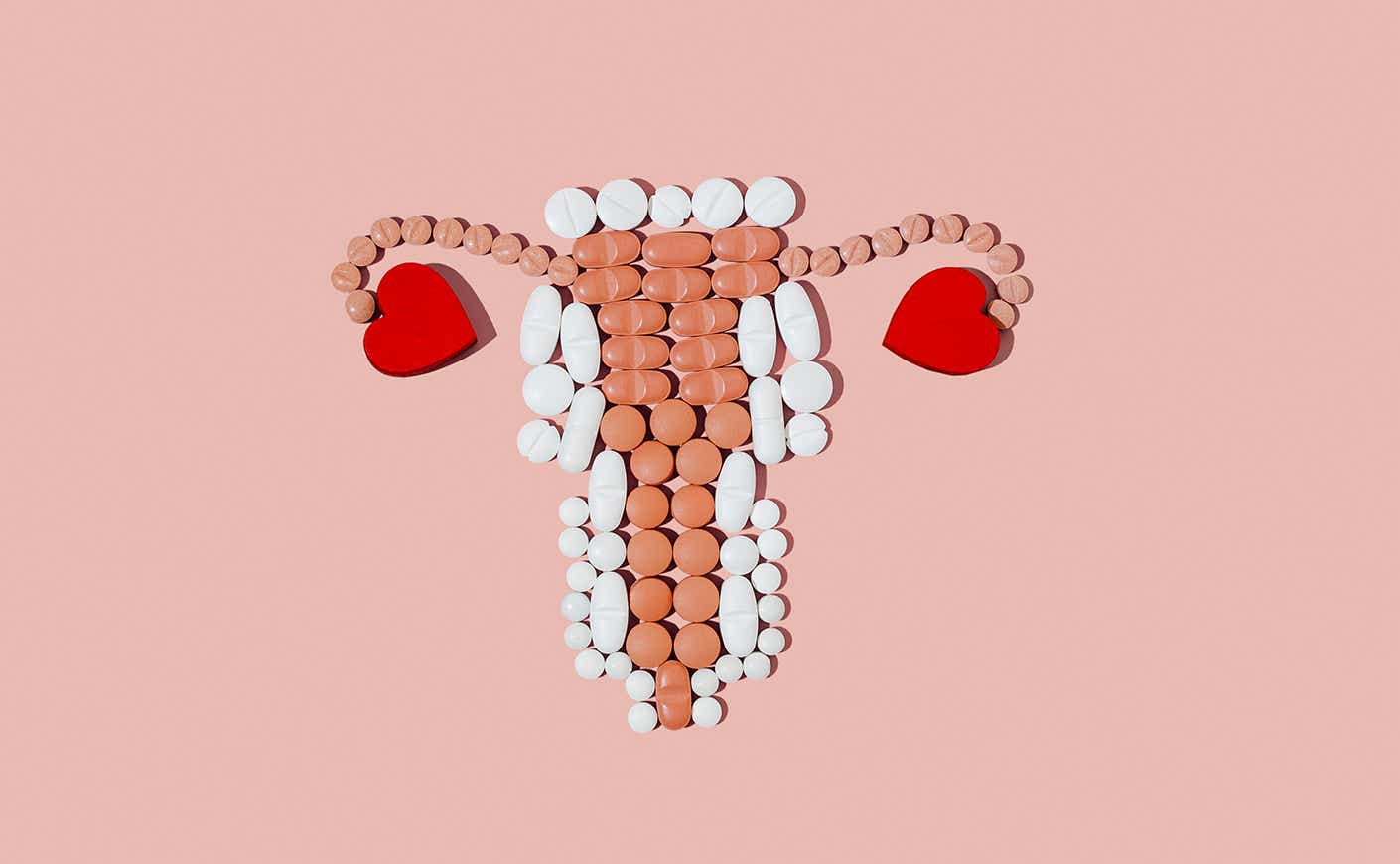 brown and white pills arranged in the shape of a uterus