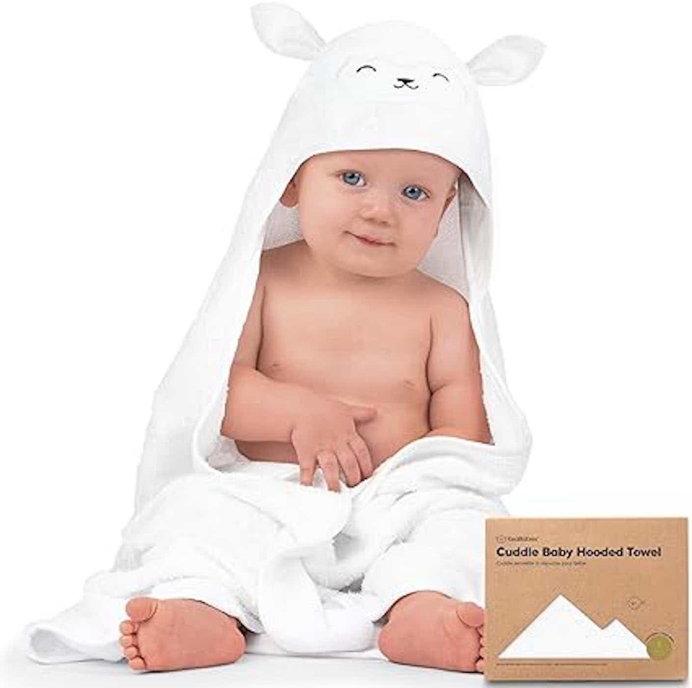 A baby wearing a hooded lamb towel