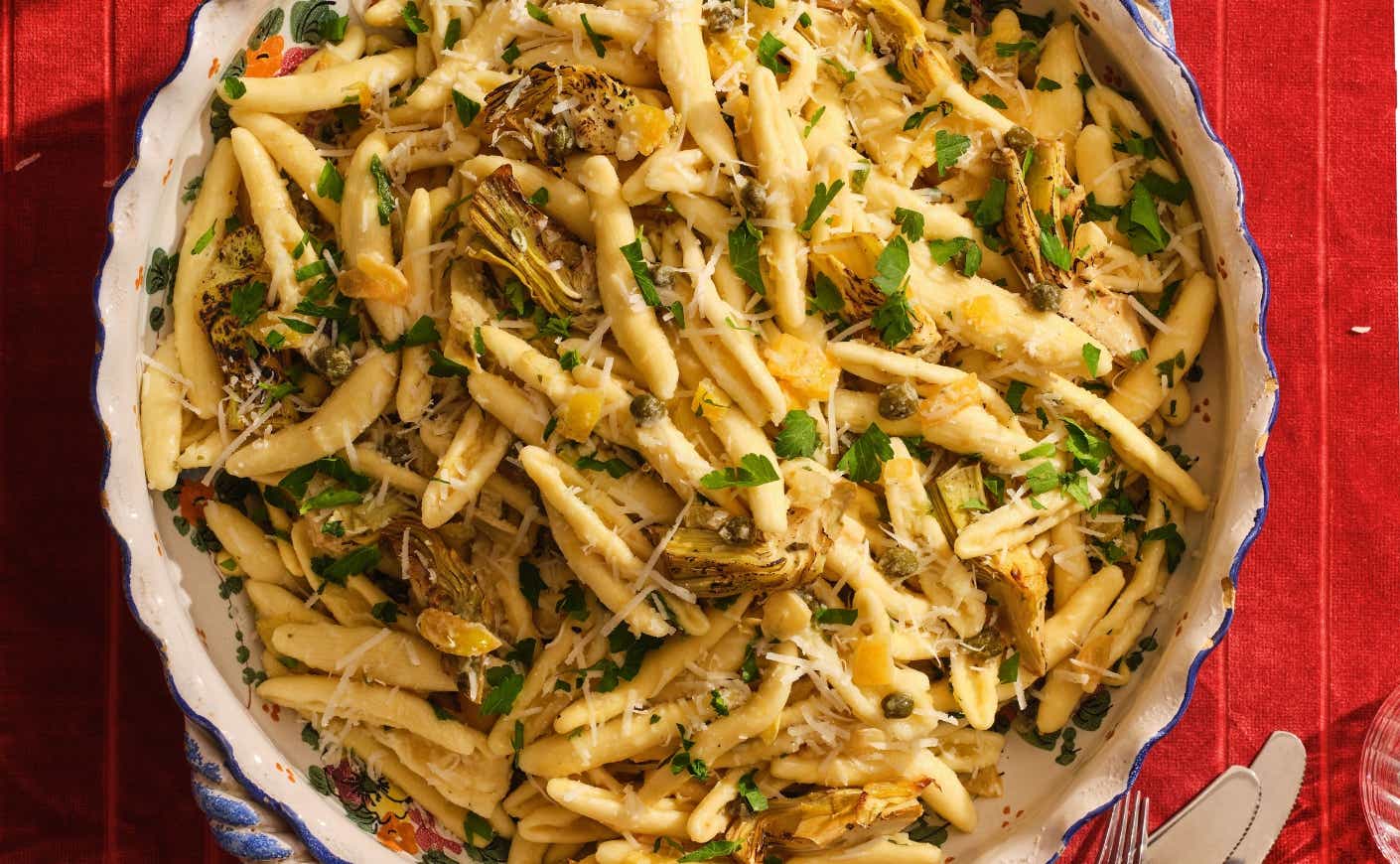 A bowl of pasta with roasted artichokes.