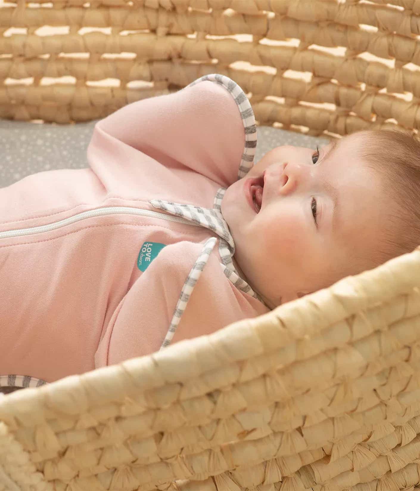 A baby wearing a swaddle up