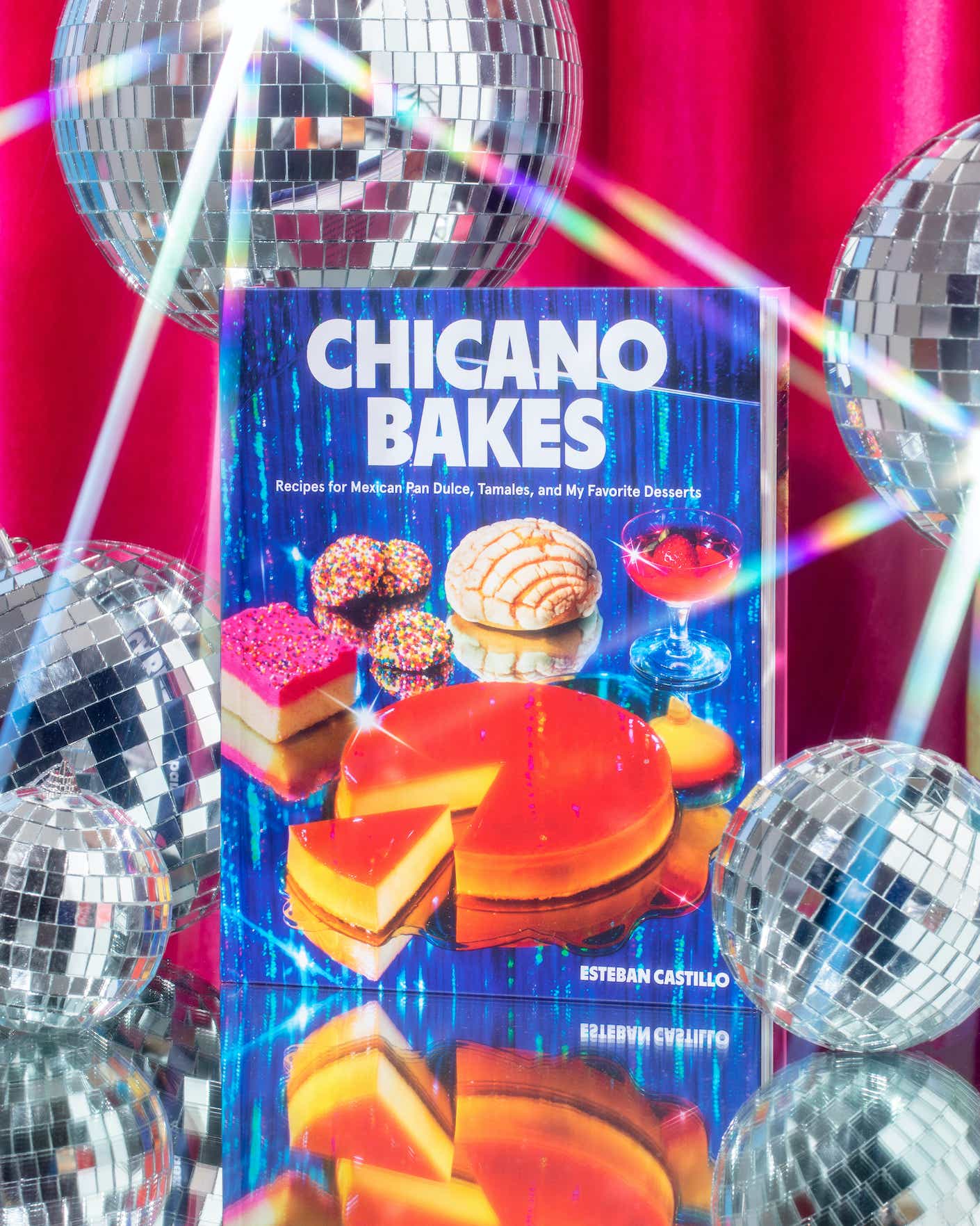 A cookbook on display with disco balls
