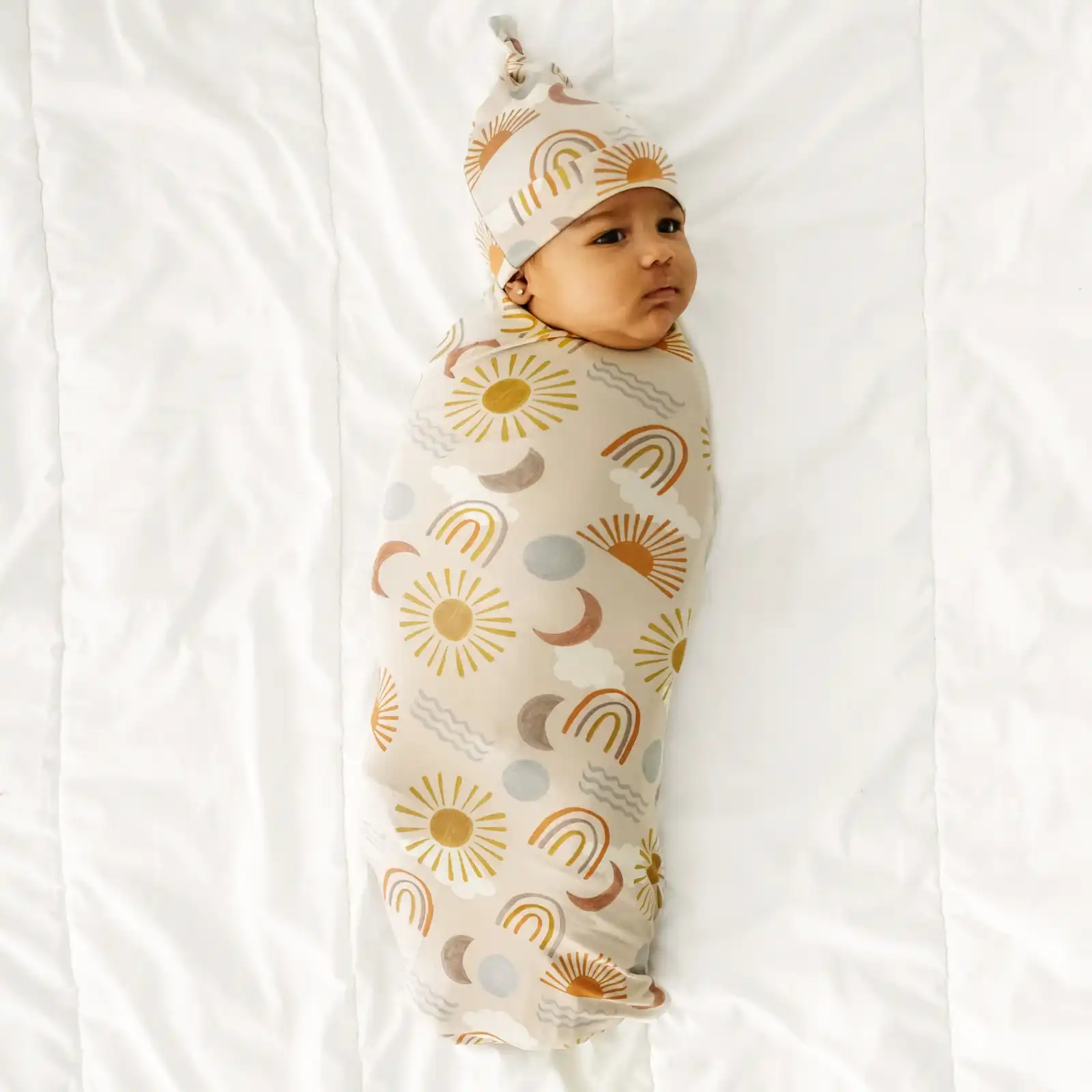 little sleepies baby wearing Desert Sunrise Swaddle & Hat Set