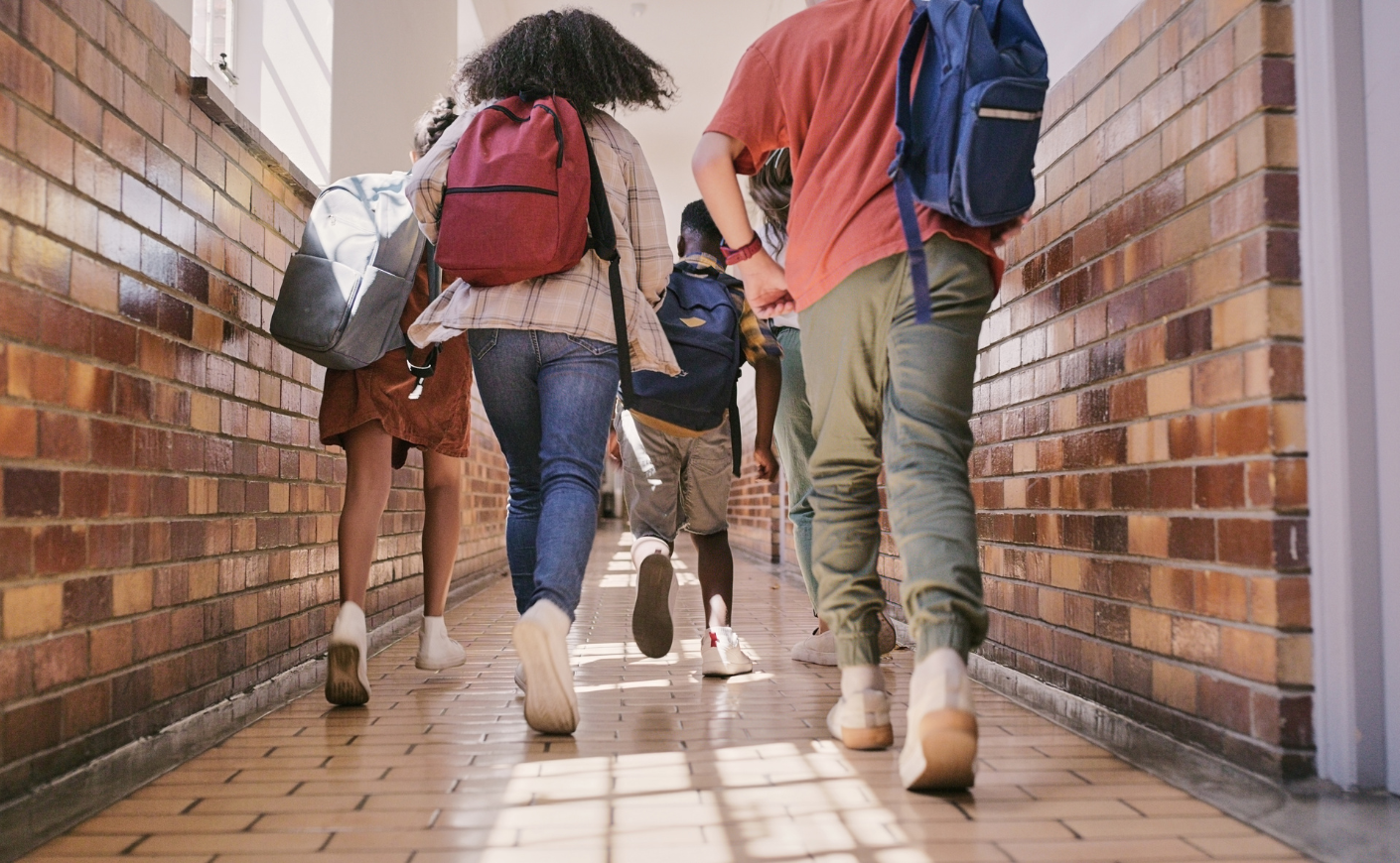 Teenagers walking down a school hallway