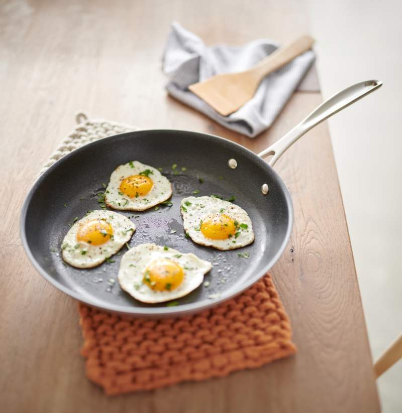 frying pan with four eggs on it