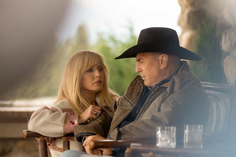 Kevin Costner as John Dutton in Yellowstone, wearing a black felt cowboy hat, talking to his daughter Beth Dutton