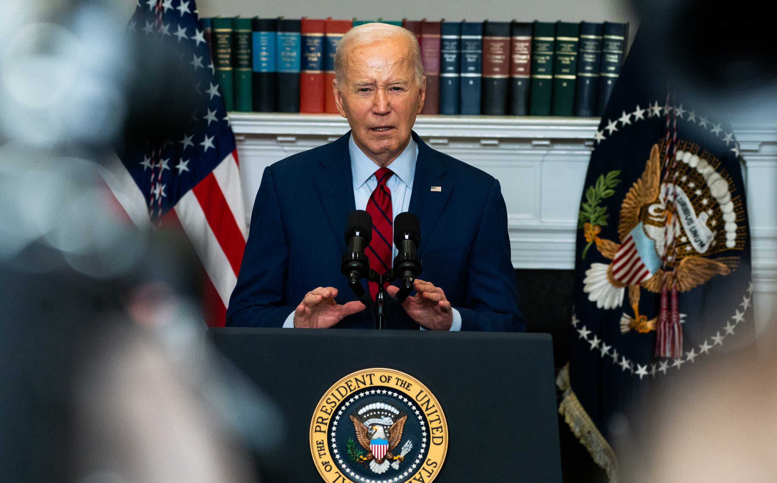 President Biden speaking on podium.