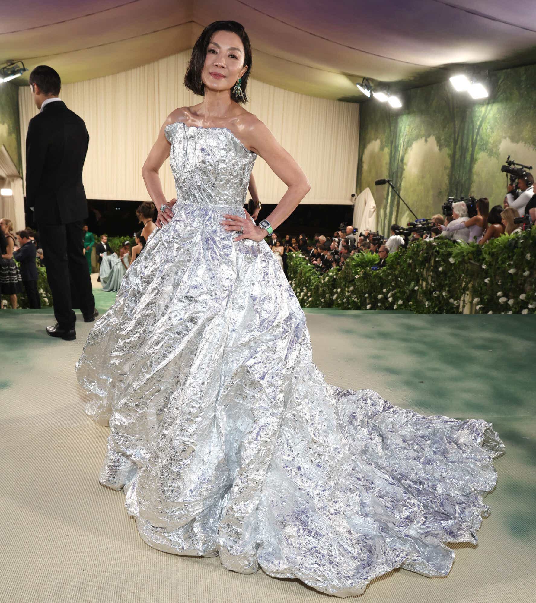Michelle Yeoh wears a strapless silver ball gown with the texture of scrunched tinfoil