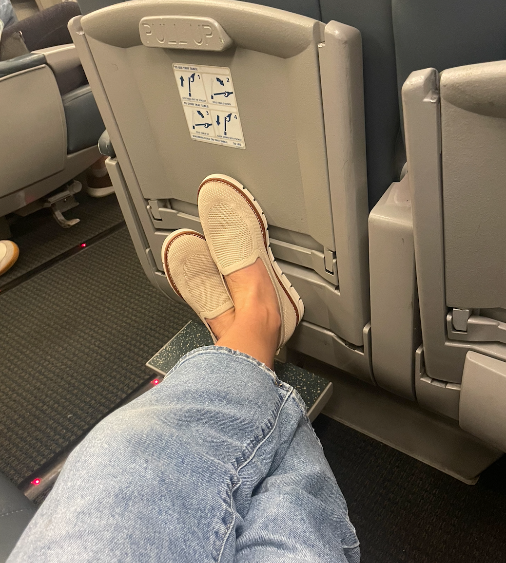 Image of feet wearing Easy Spirit loafers on a train