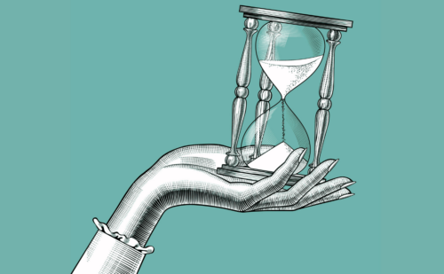 A hand holding up an hourglass.