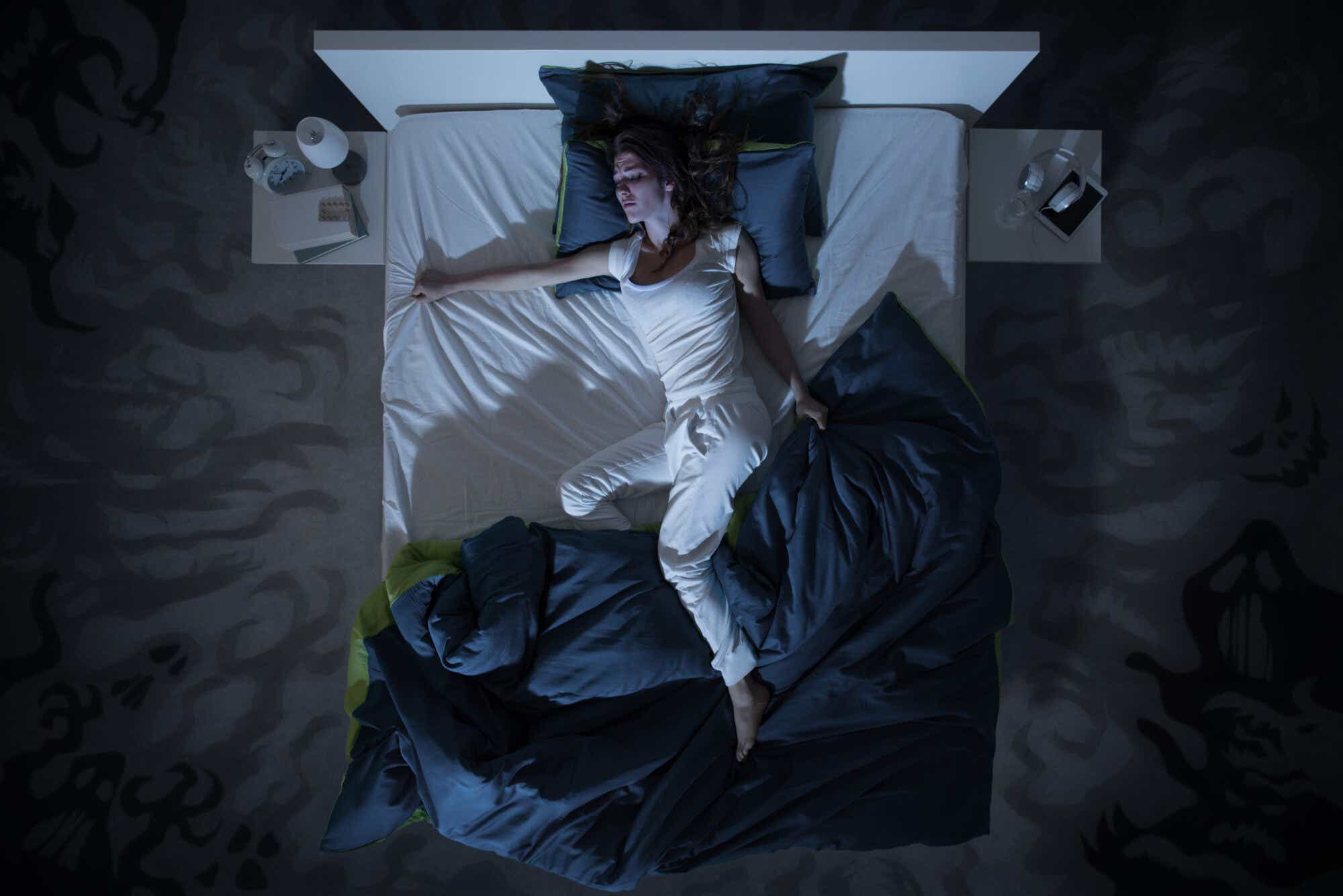 Woman in bed with the cover thrown over her