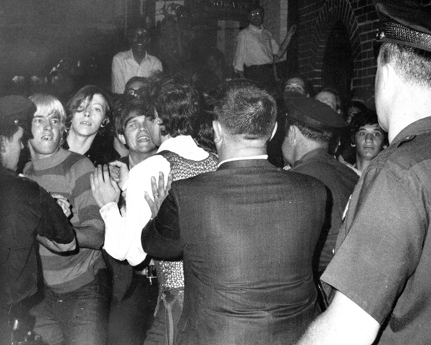 UNITED STATES - JUNE 28:  Stonewall Inn nightclub raid. Crowd attempts to impede police arrests outside the Stonewall Inn on Christopher Street in Greenwich Village.  (Photo by NY Daily News Archive via Getty Images)