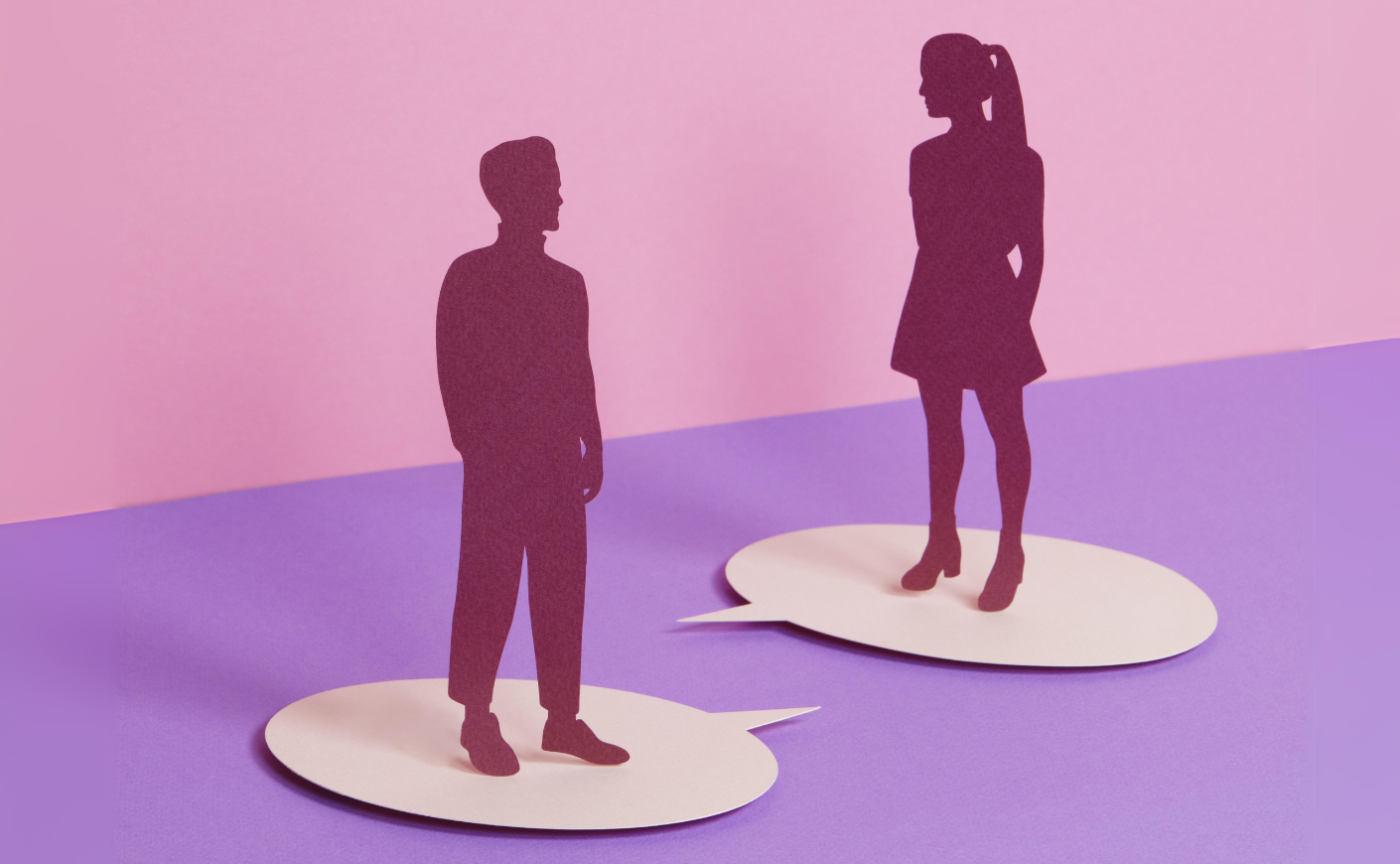 Illustration of a couple facing one another, standing on cutouts of thought bubbles