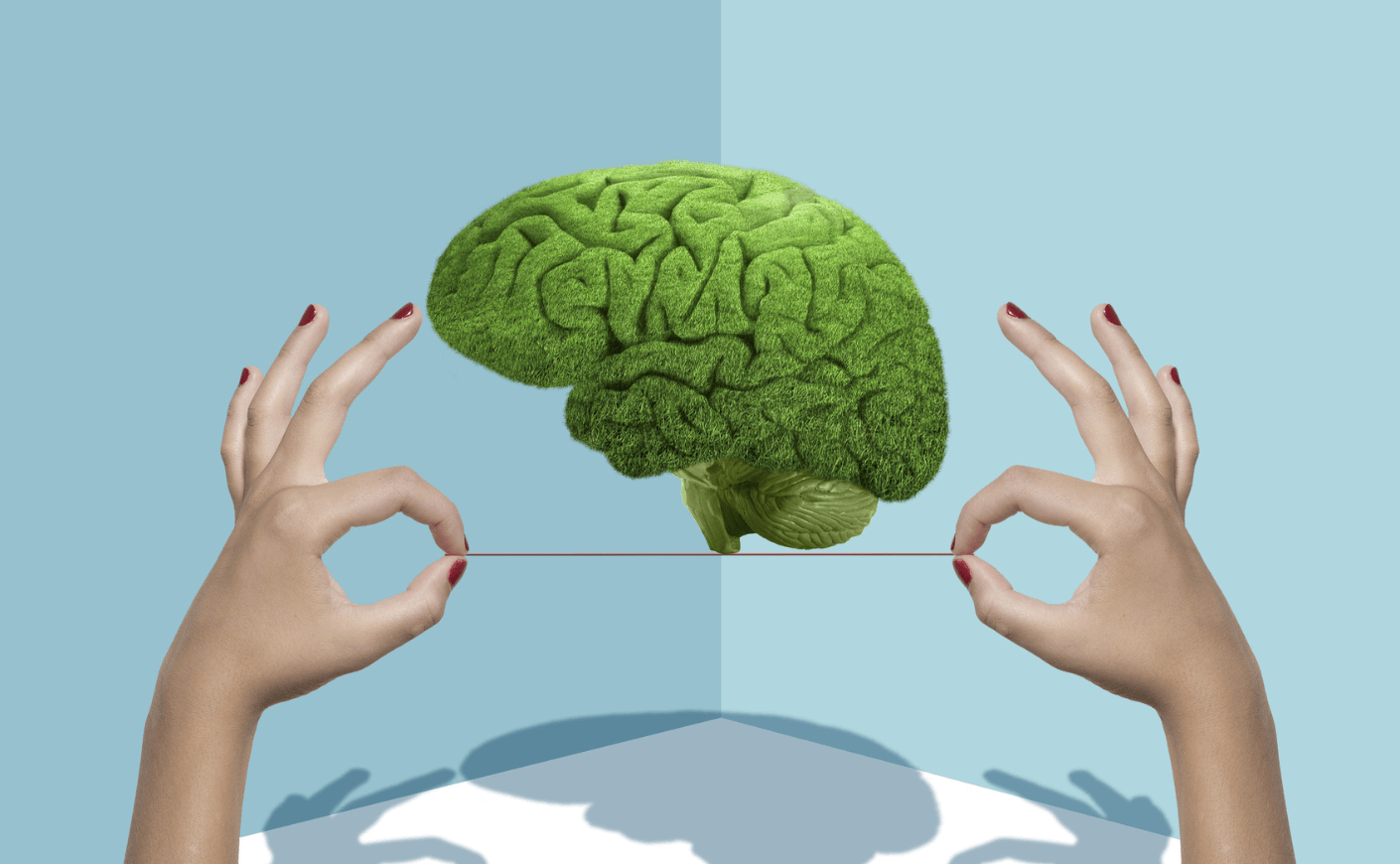 a green brain balancing on a wire