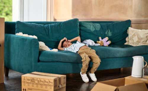 a kid sliding off a couch