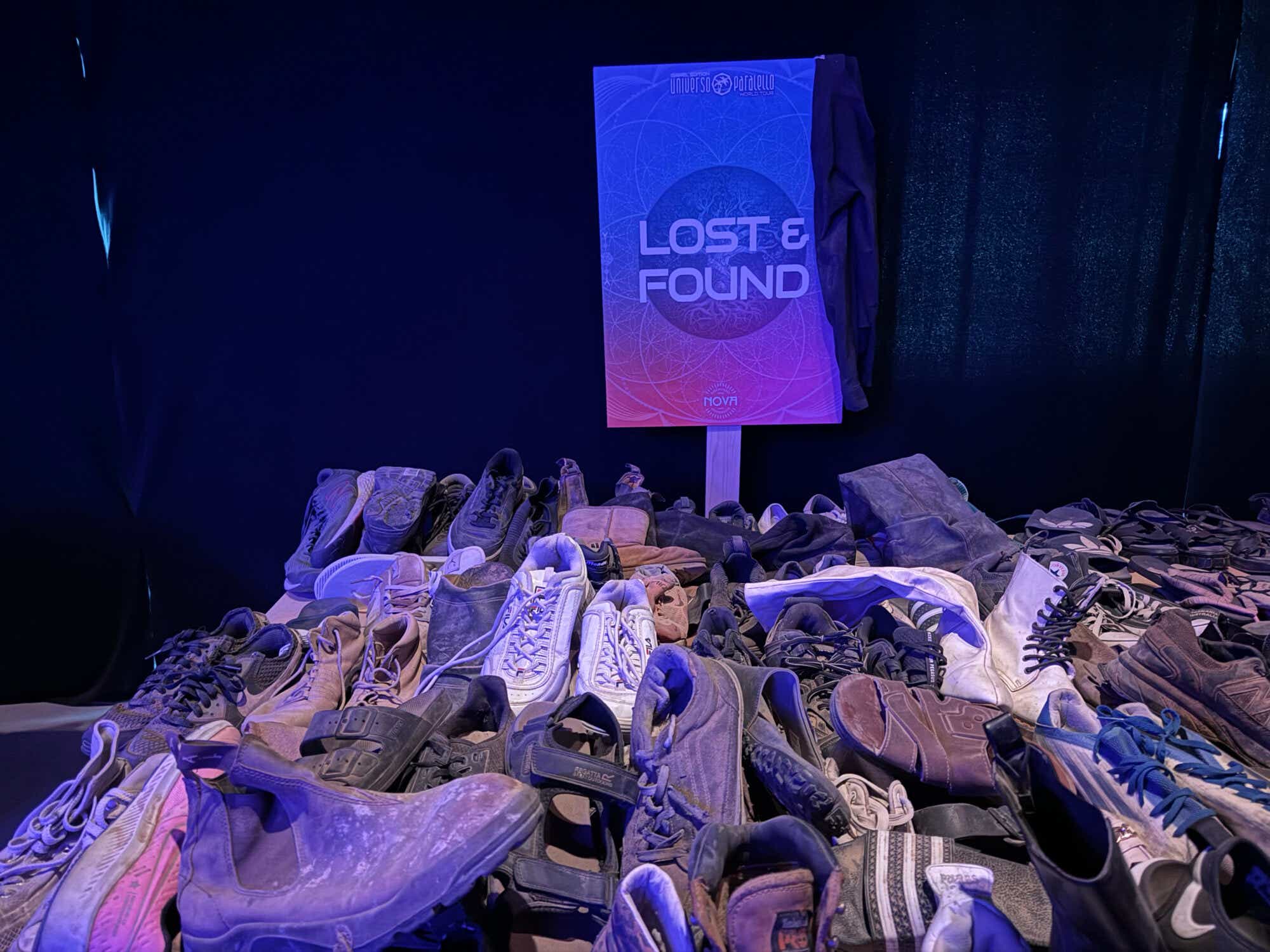 A pile of shoes with a sign that says "Lost & Found" from the Nova exhibition.