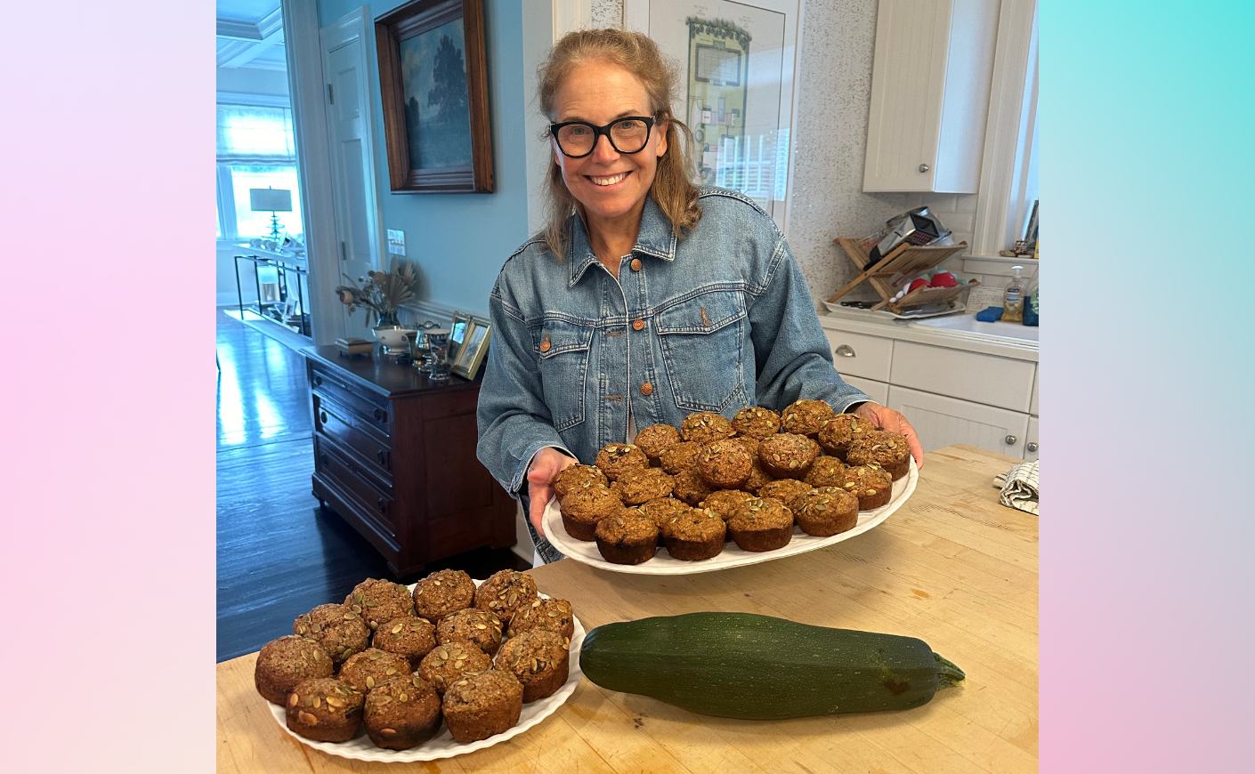 Katie Couric holding bran muffins in the kitchen