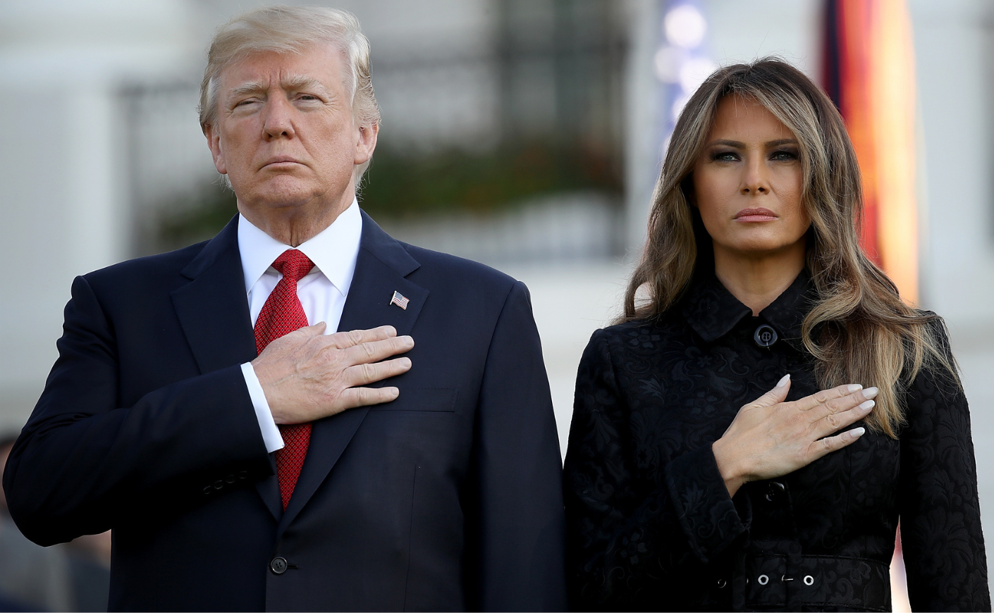 Donald Trump and Melania Trump with their hands over their hearts