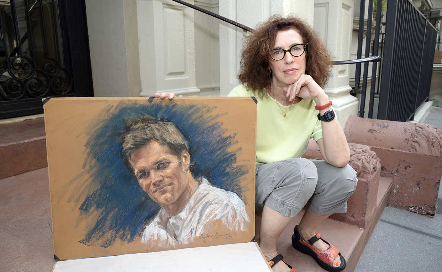 Jane Rosenberg holding a sketch of Tom Brady