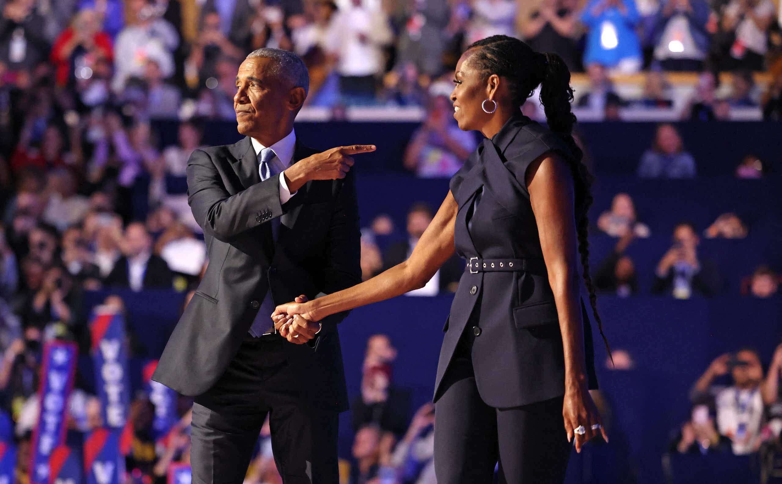 Former US First Lady Michelle Obama (R) introduces Former US President Barack Obama on the second day of the Democratic National Convention (DNC) at the United Center in Chicago, Illinois, on August 20, 2024. Vice President Kamala Harris will formally accept the party’s nomination for president at the DNC