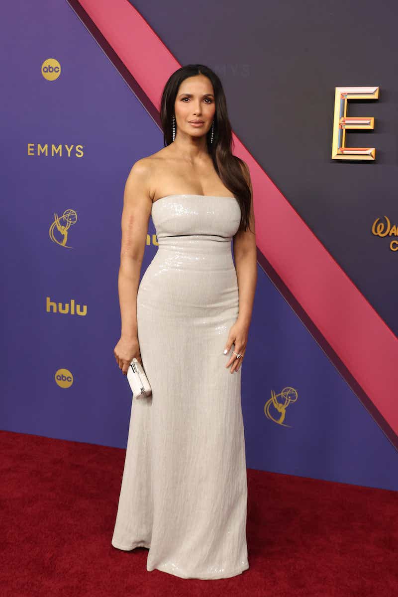 Padma Lakshmi attends the Emmys in a sequined strapless off-white dress.