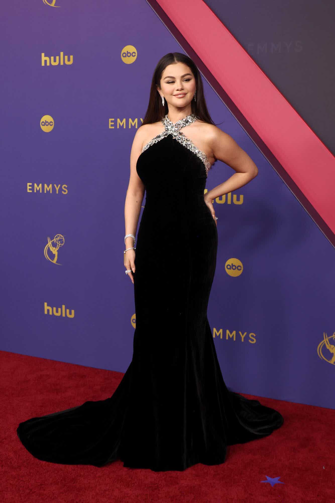 Selena Gomez in a black gown with a high-neck halter and silver beading on the neckline