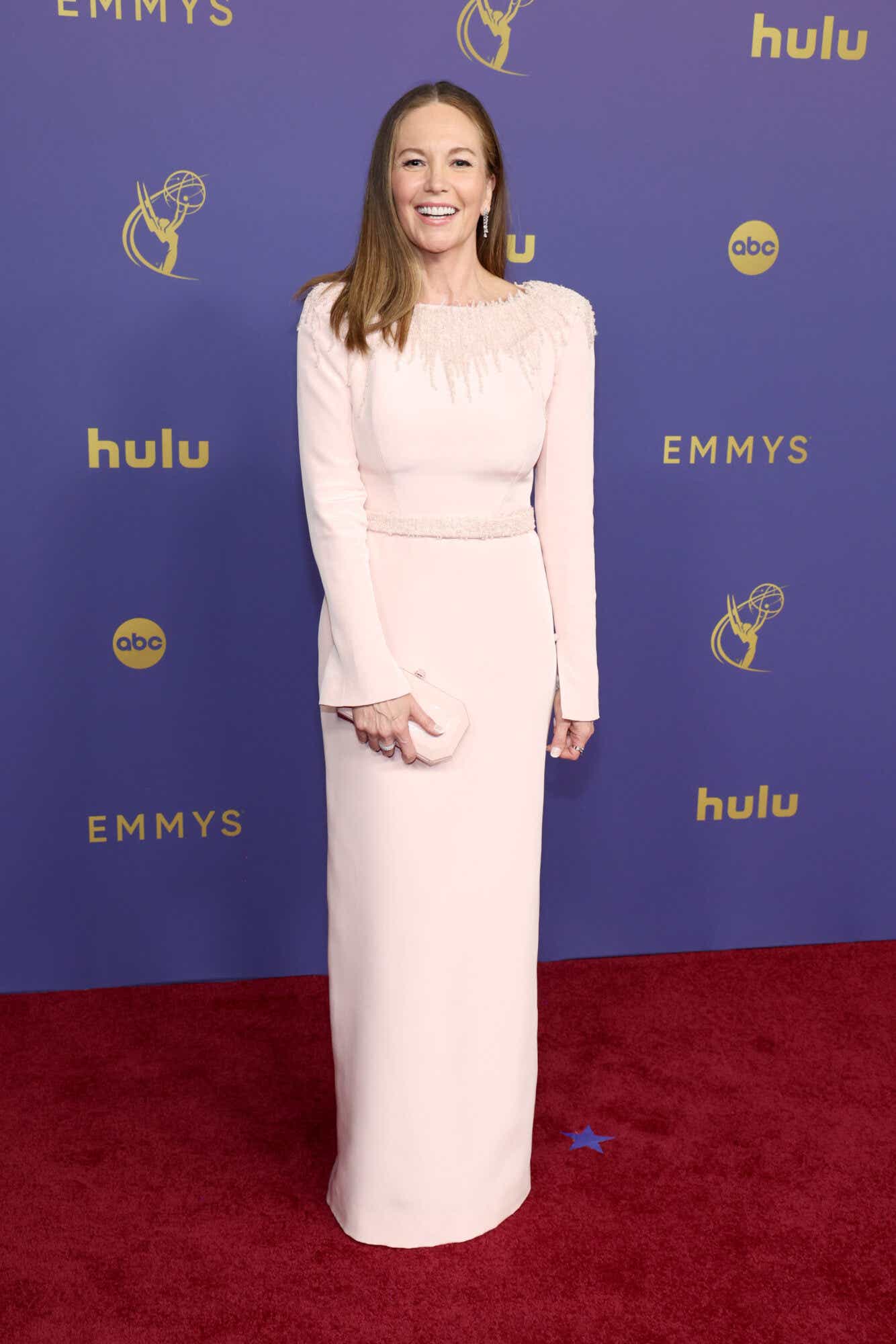 Diane Lane wears a long-sleeved pale pink gown to the Emmys.