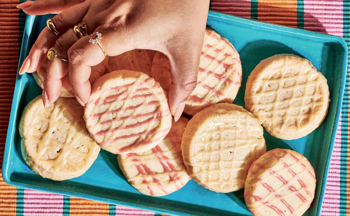 a tray of butter cookies with icing