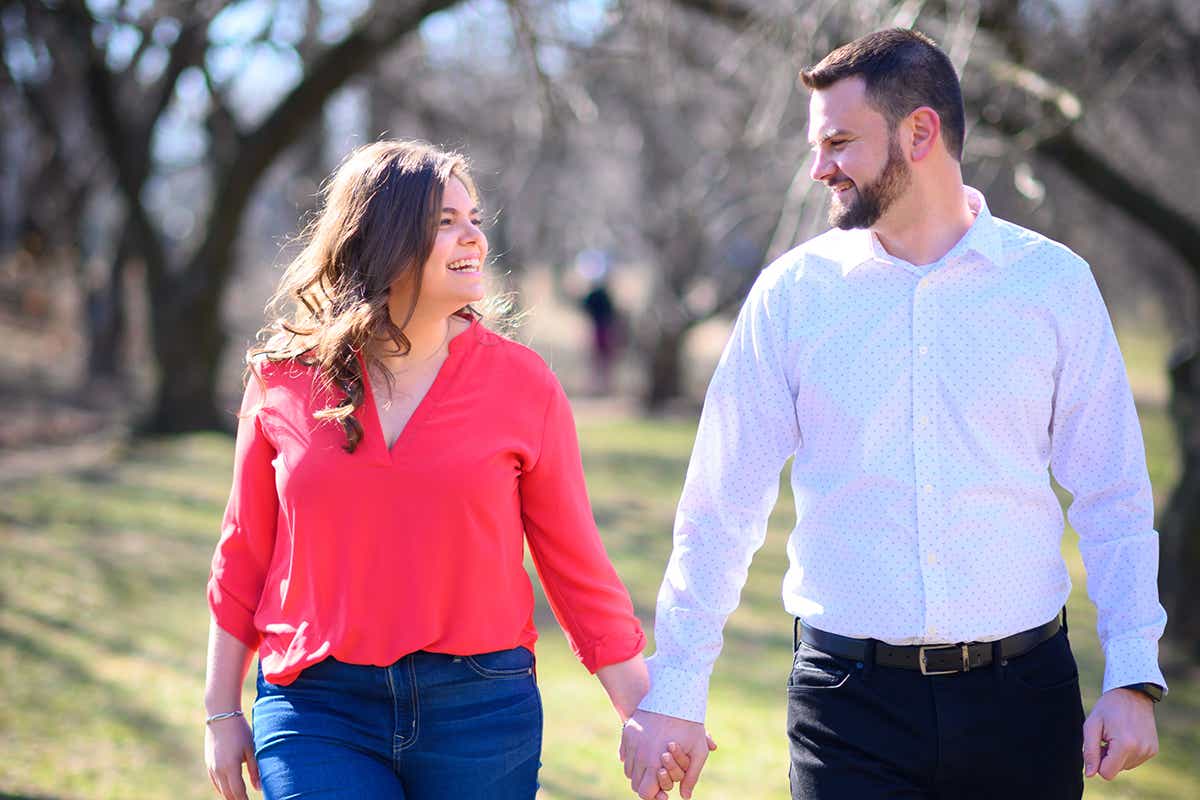 Rachel and her now-husband Brandon smile at each other during engagement photoshoot