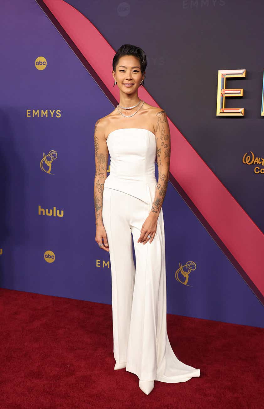 Kristen Kish wears a structured strapless white jumpsuit to the Emmys.