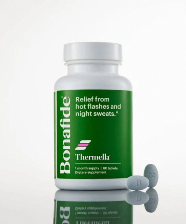 Thermella bottle and pills on a reflective surface