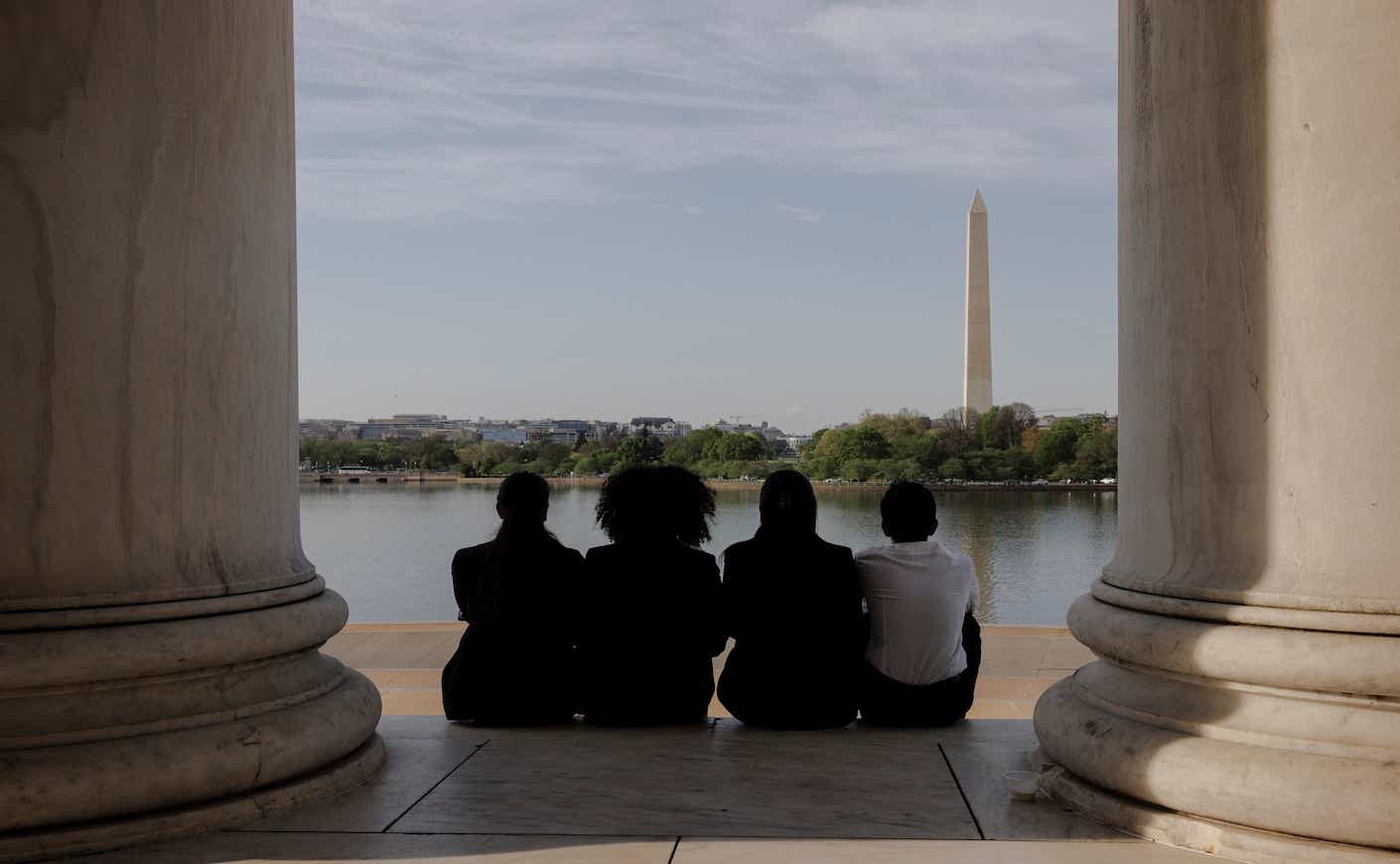 Four competitors in the We the People national championship viewed the Washington Monument from the Thomas Jefferson Memorial in Washington, D.C.