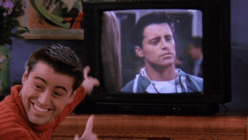 Joey Tribbiani excitedly pointing to himself on TV.