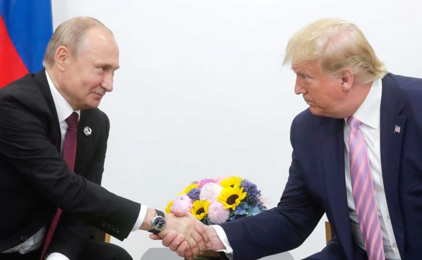 Vladimir Putin and Donald Trump shaking hands