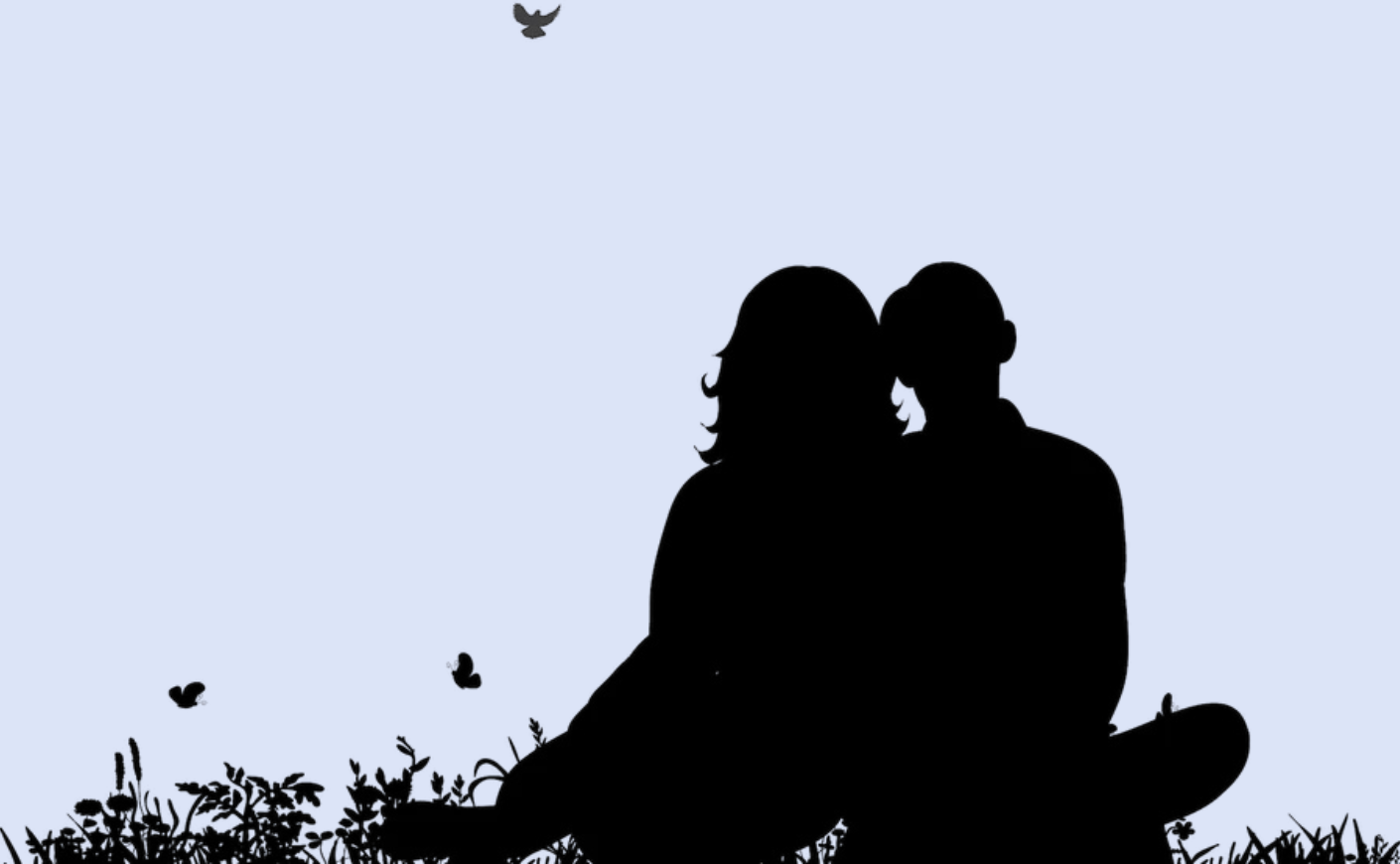 Silhouette of man and woman leaning against one another sitting on grass