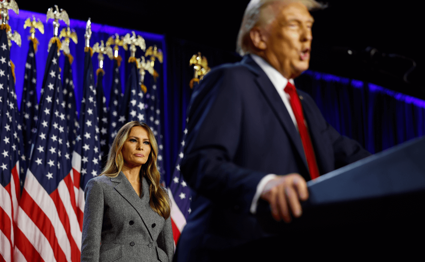 Melania Trump behind Donald at a campaign event