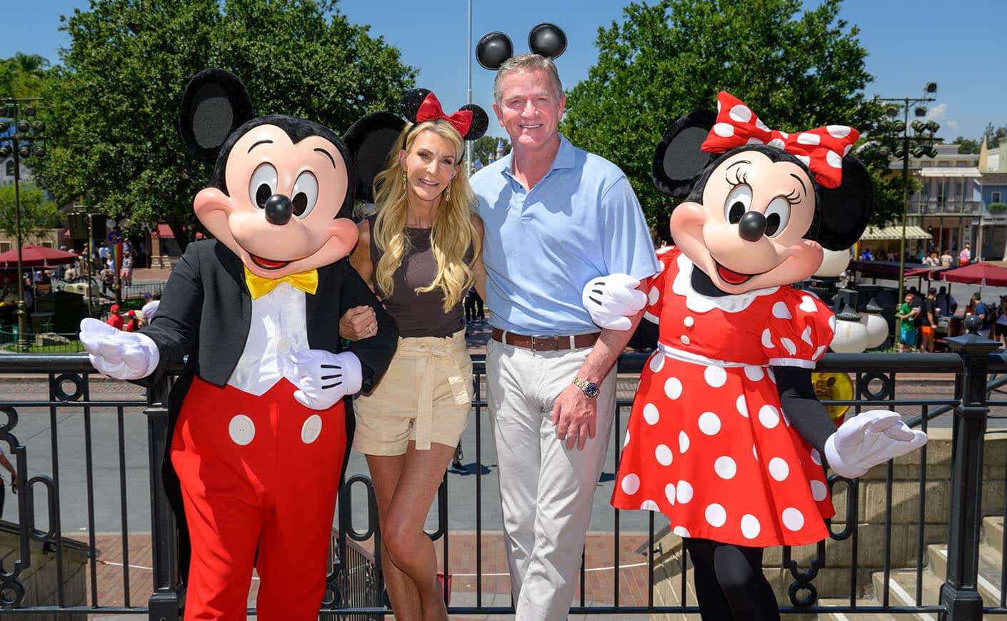 Joan Vassos and Chock Chapple pose with Mickey and Minnie Mouse at Disney.