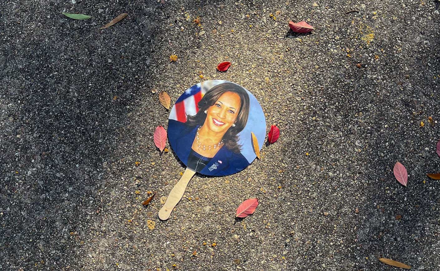 a sign for kamala harris on the ground