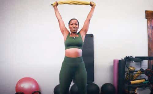 sheryl grant doing a shoulder press with a towel