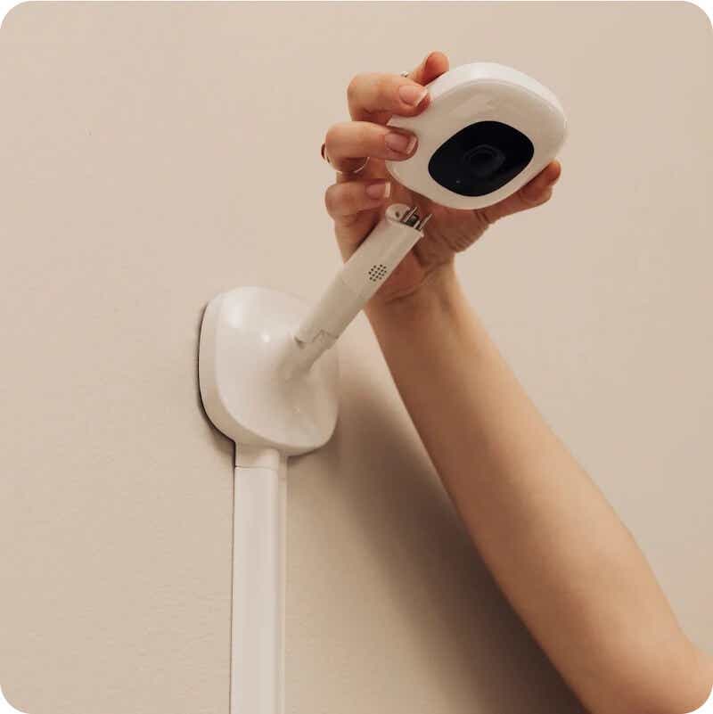 woman's hand putting up baby monitor