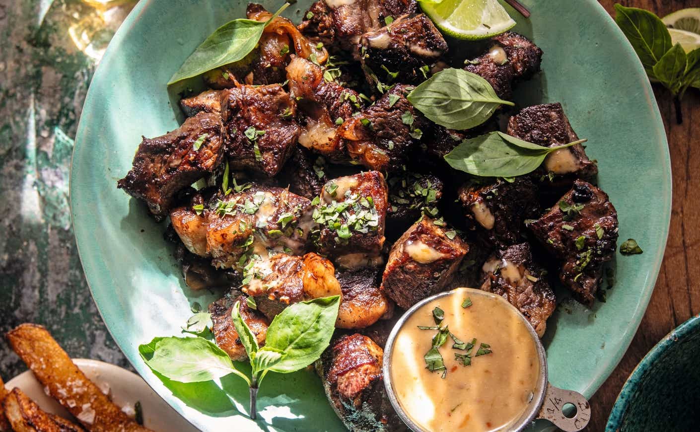 A plate of steak bites and bang bang sauce.