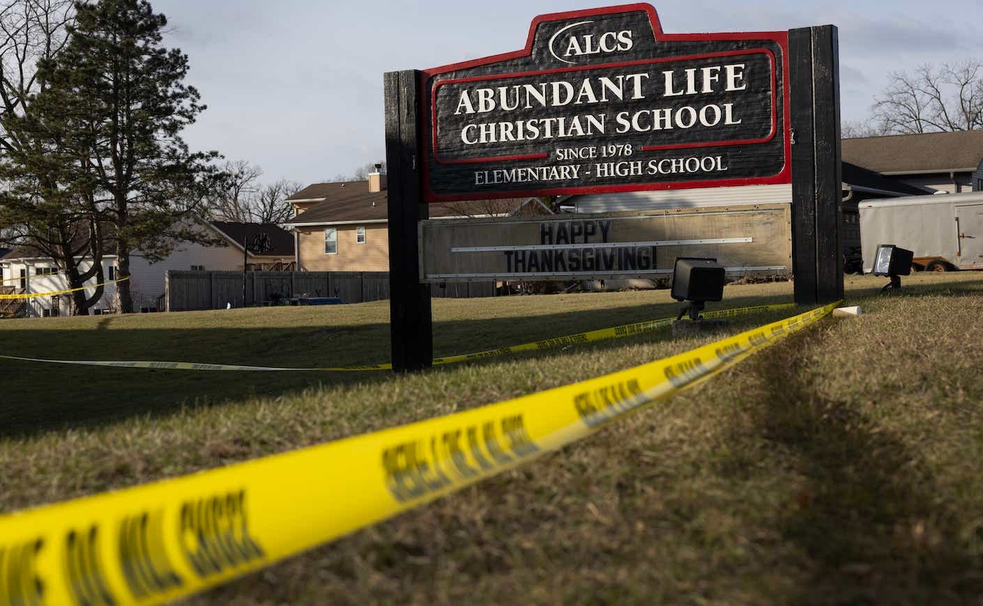 abundant life school sign in wisconsin with caution tape around it