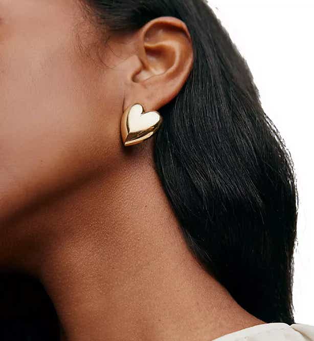 woman wearing heart earrings