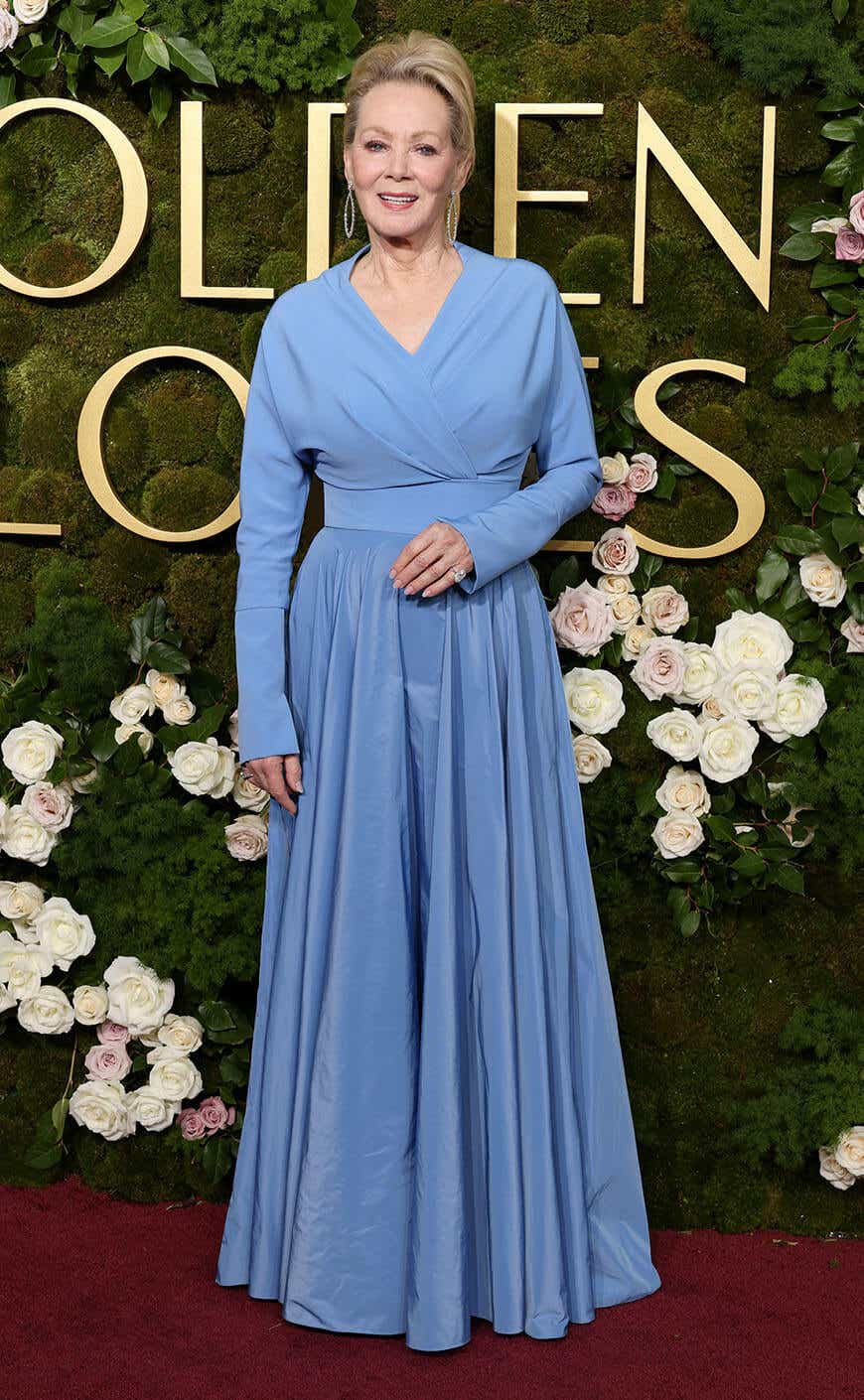 Jean Smart wears a sky blue gown with long sleeves to the Golden Globes.