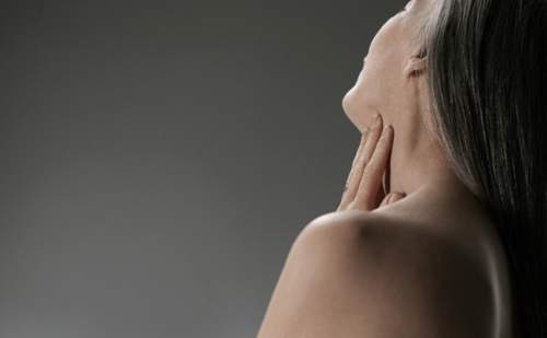 senior woman touching her neck