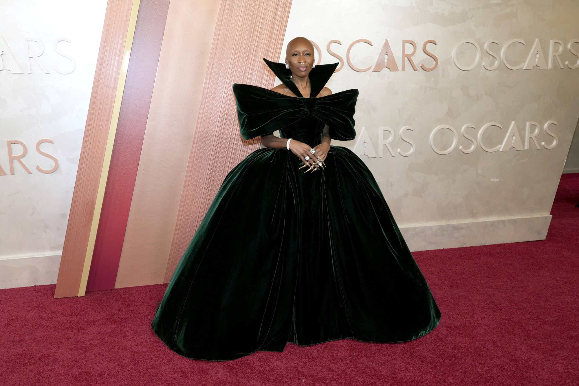 Cynthia Erivo stuns in a dramatic velvet gown with a high collar, off-the-shoulder neckline, and voluminous skirt.