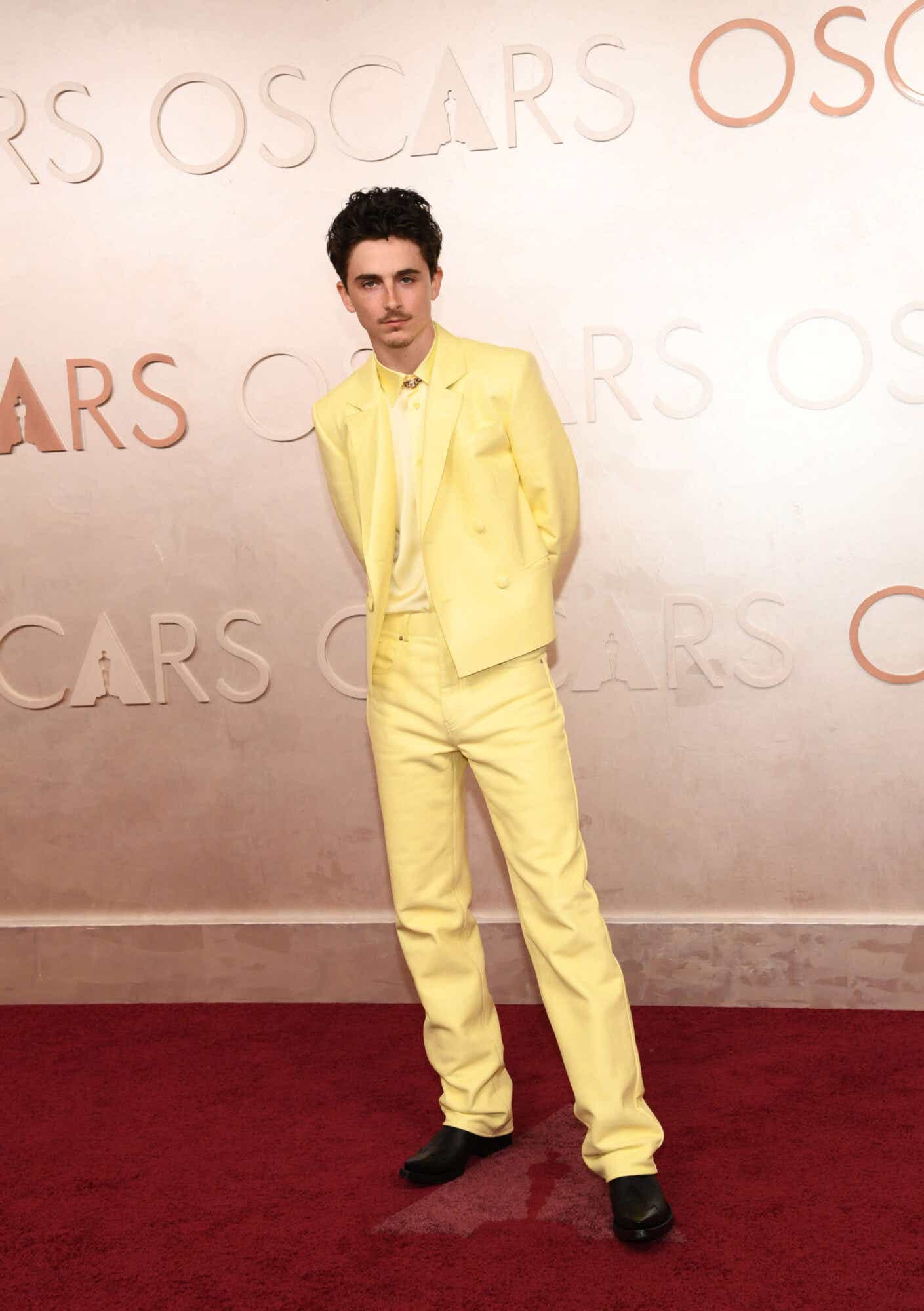 Timothée Chalamet wears a yellow suit to the Oscars.