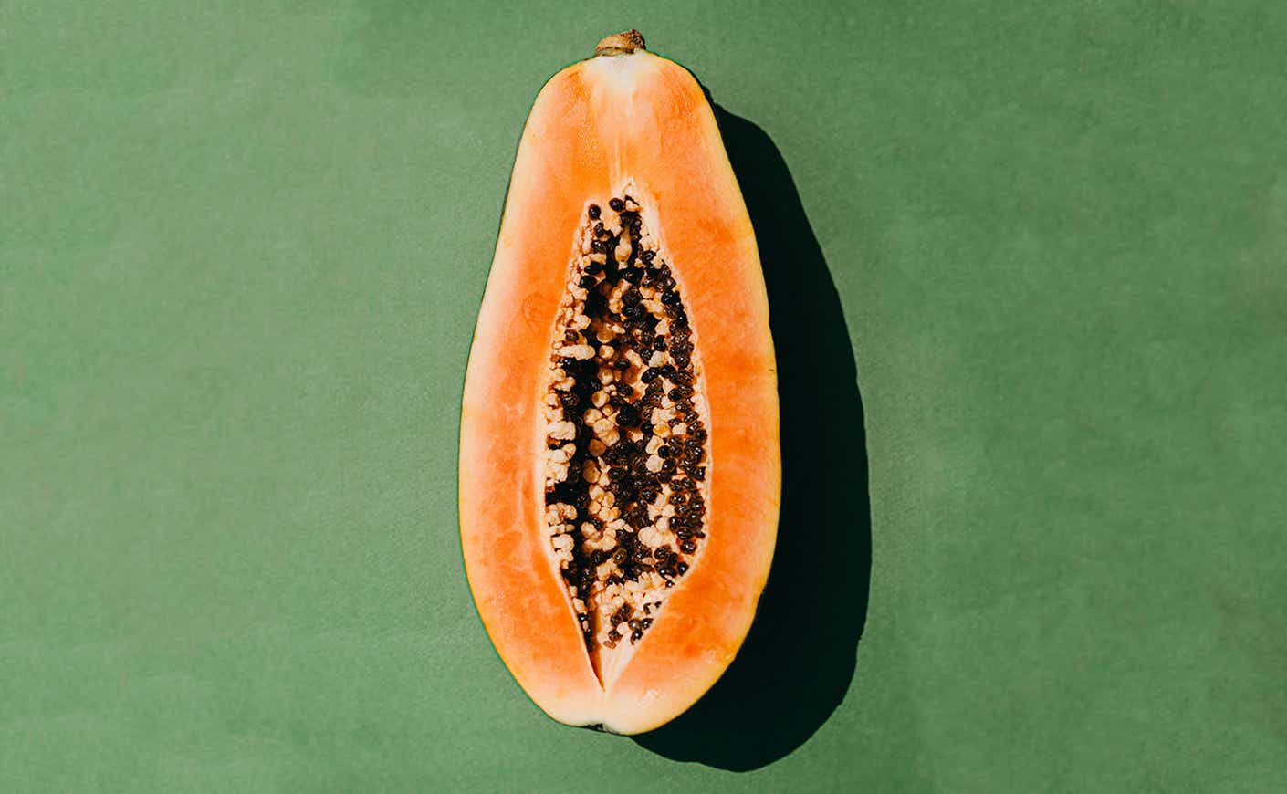 papaya on green background