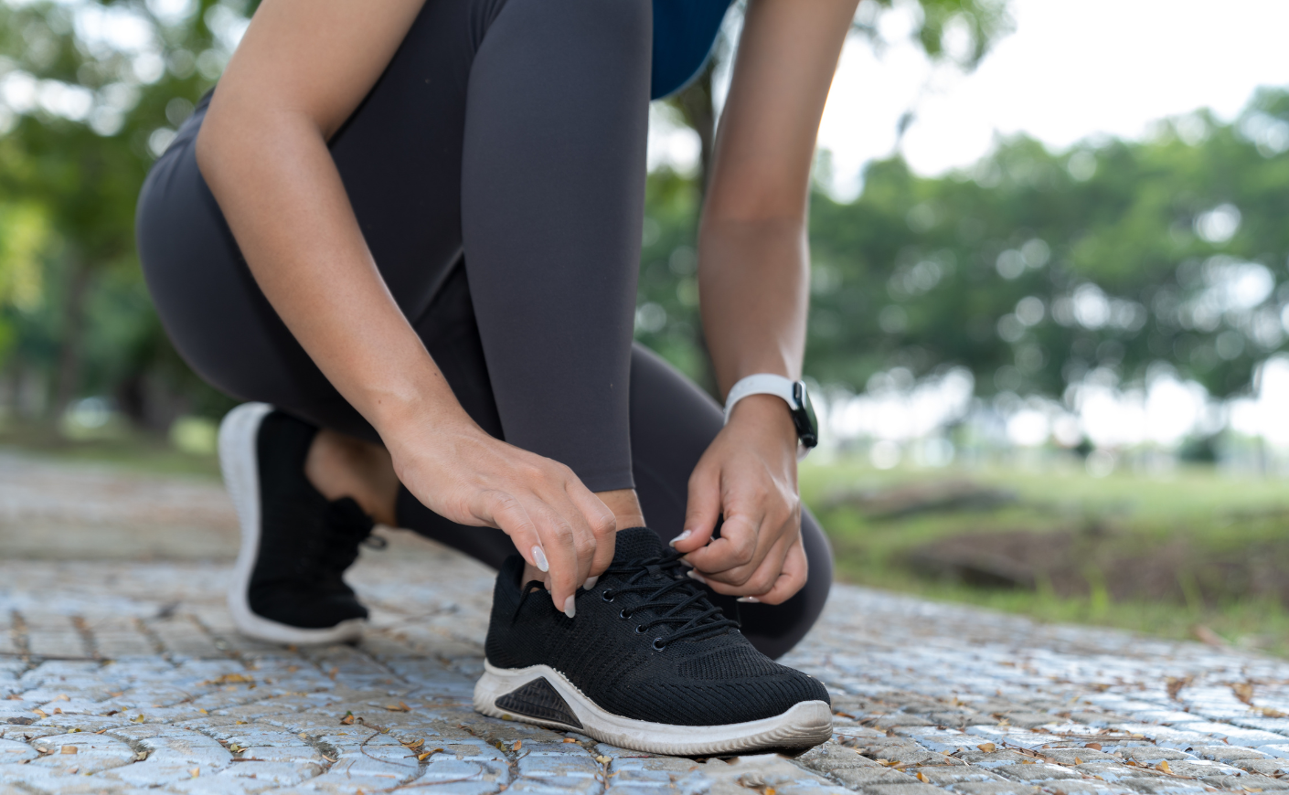 Woman lacing up running shoes